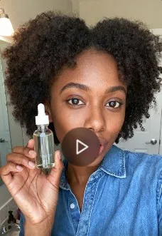 A creator holds a serum bottle up to the camera